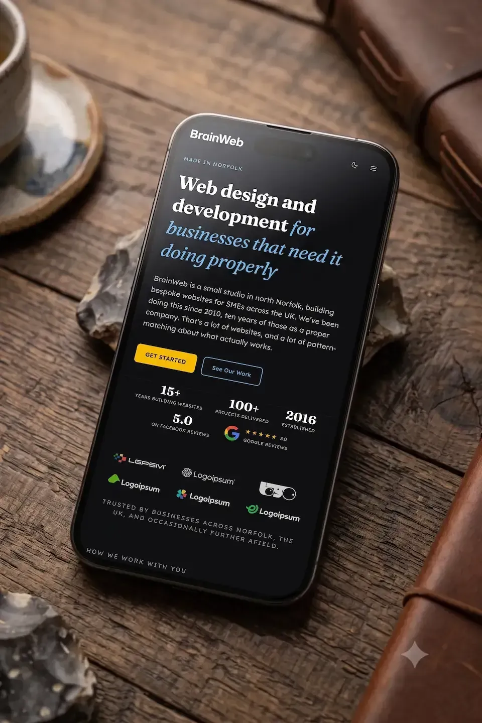 A mockup of our new website, showing the dark theme on a mobile. The screenshot was taken while the website was under development, and the mockup was created using Gemini. 