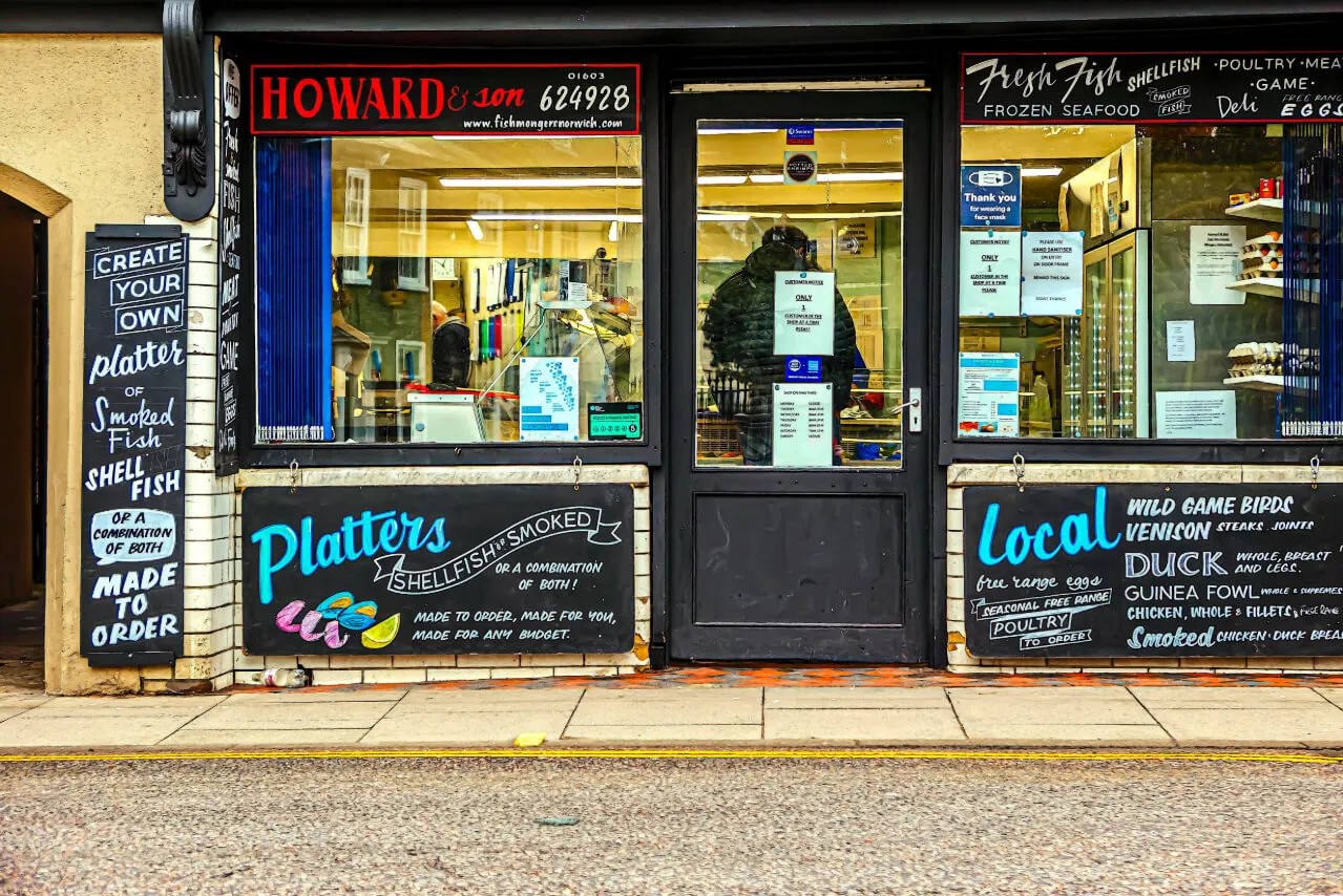A shopfront with a painted offers and sinage, the kind of local business still found through Google's local map pack rather than an AI summary
